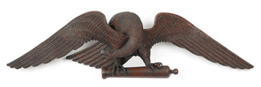 Pennsylvania carved mahogany spread winged eagle, circa 1870, finely detailed with its talons clasping a cannon, retaining its original varnished surface, 72 inches, $59,250. Image courtesy of Pook & Pook Inc.